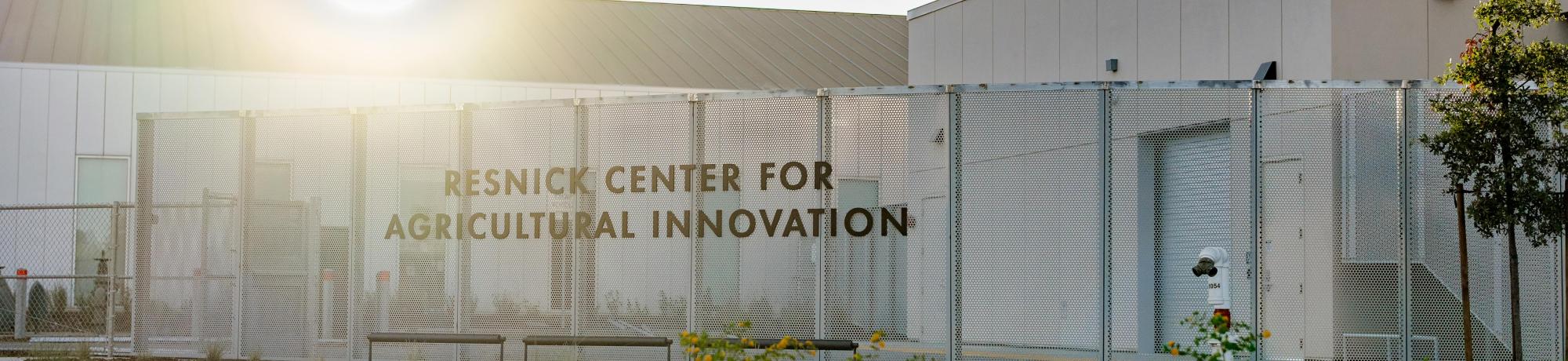 Resnick Agricultural Innovation Center exterior with fence, roadside and bright sun glare
